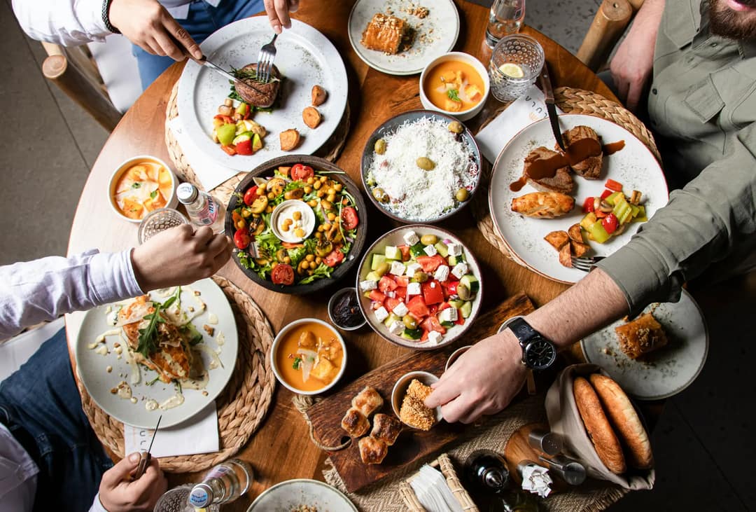 Friends sharing a spread of dishes