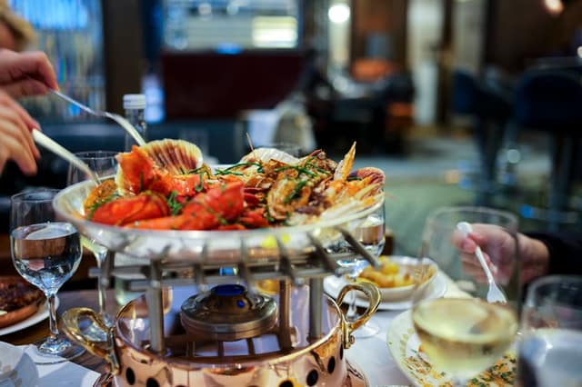 A spread of restaurant dishes containing hidden shellfish you wouldn't expect, helping diners identify unexpected ingredients safely